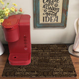a red coffee machine sitting on top of a rug