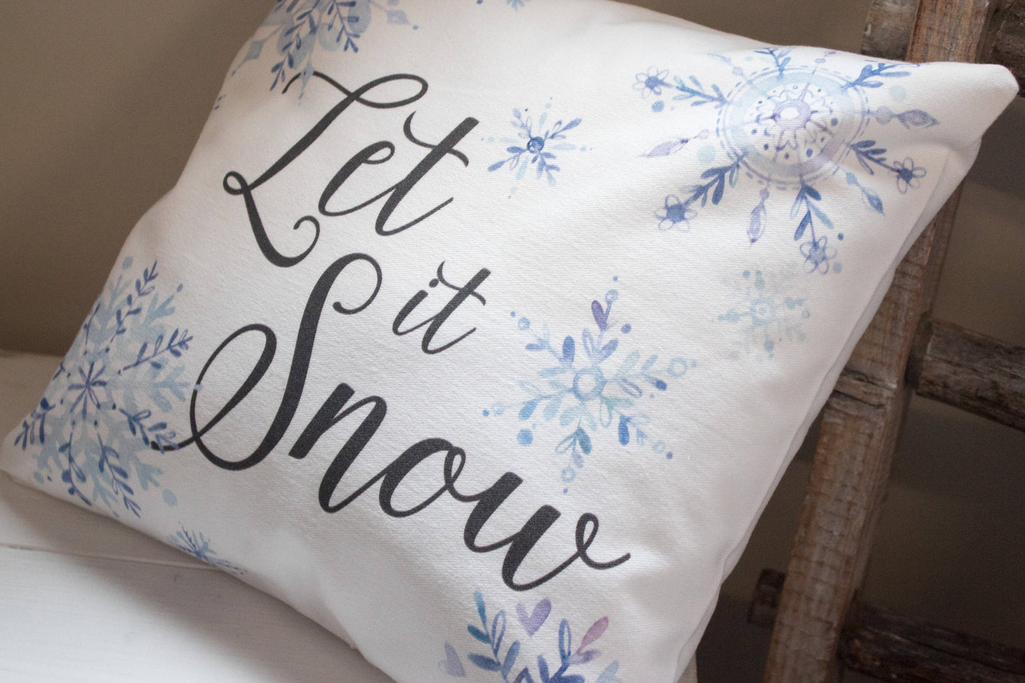 Let it Snow winter decor throw pillow with blue watercolor snowflakes