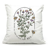 a white pillow with a picture of a plant and bees on it