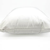 a white pillow sitting on top of a white floor