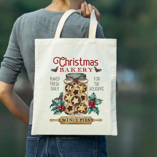 a woman carrying a christmas bakery bag