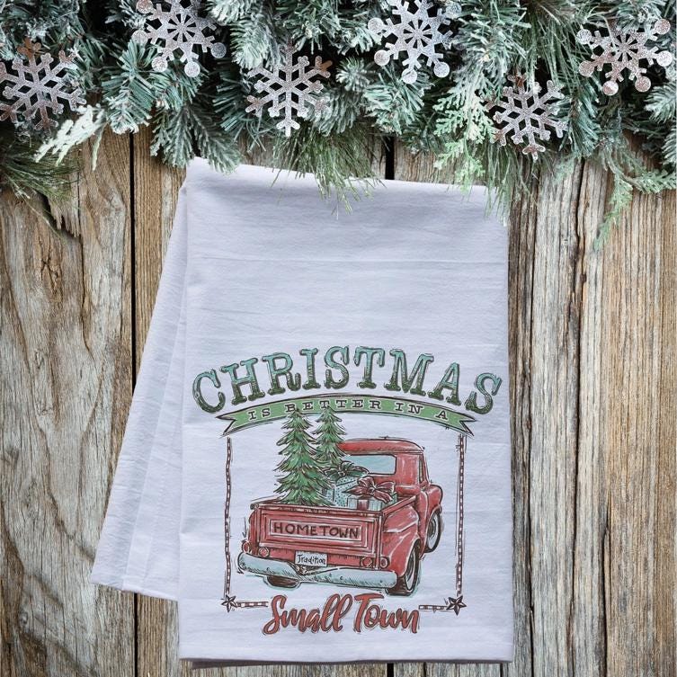 a white towel with a red truck and christmas tree on it