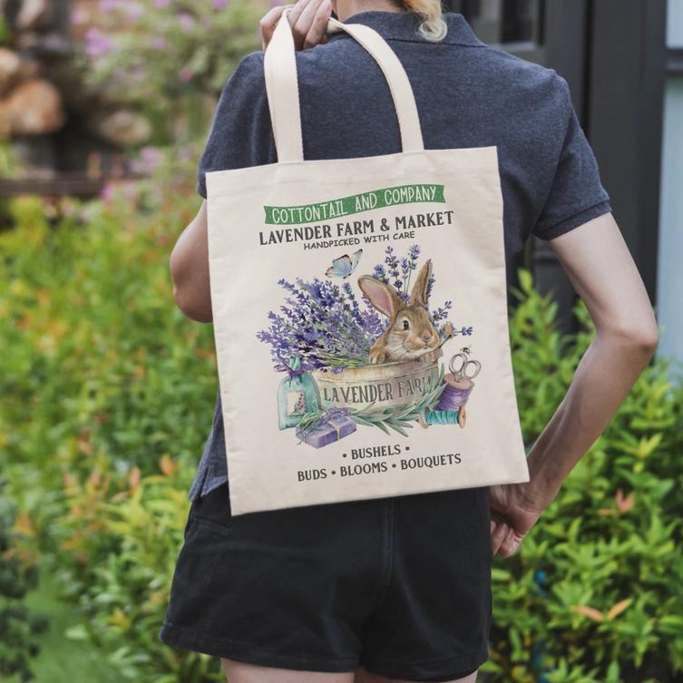 a woman holding a bag with lavender plants on it