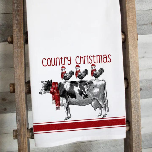 a kitchen towel with a cow and chickens on it