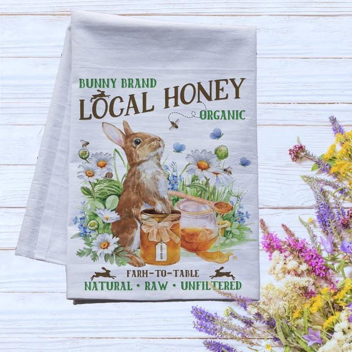 a tea towel with a picture of a bunny holding a jar of honey