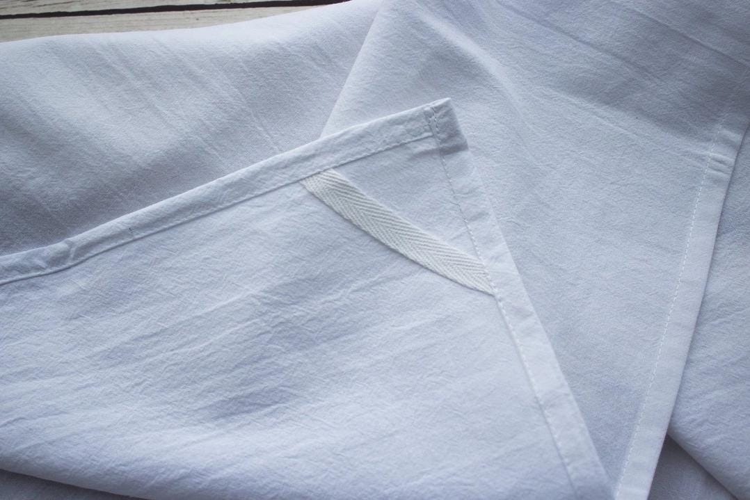 a pile of white linens folded up on top of each other