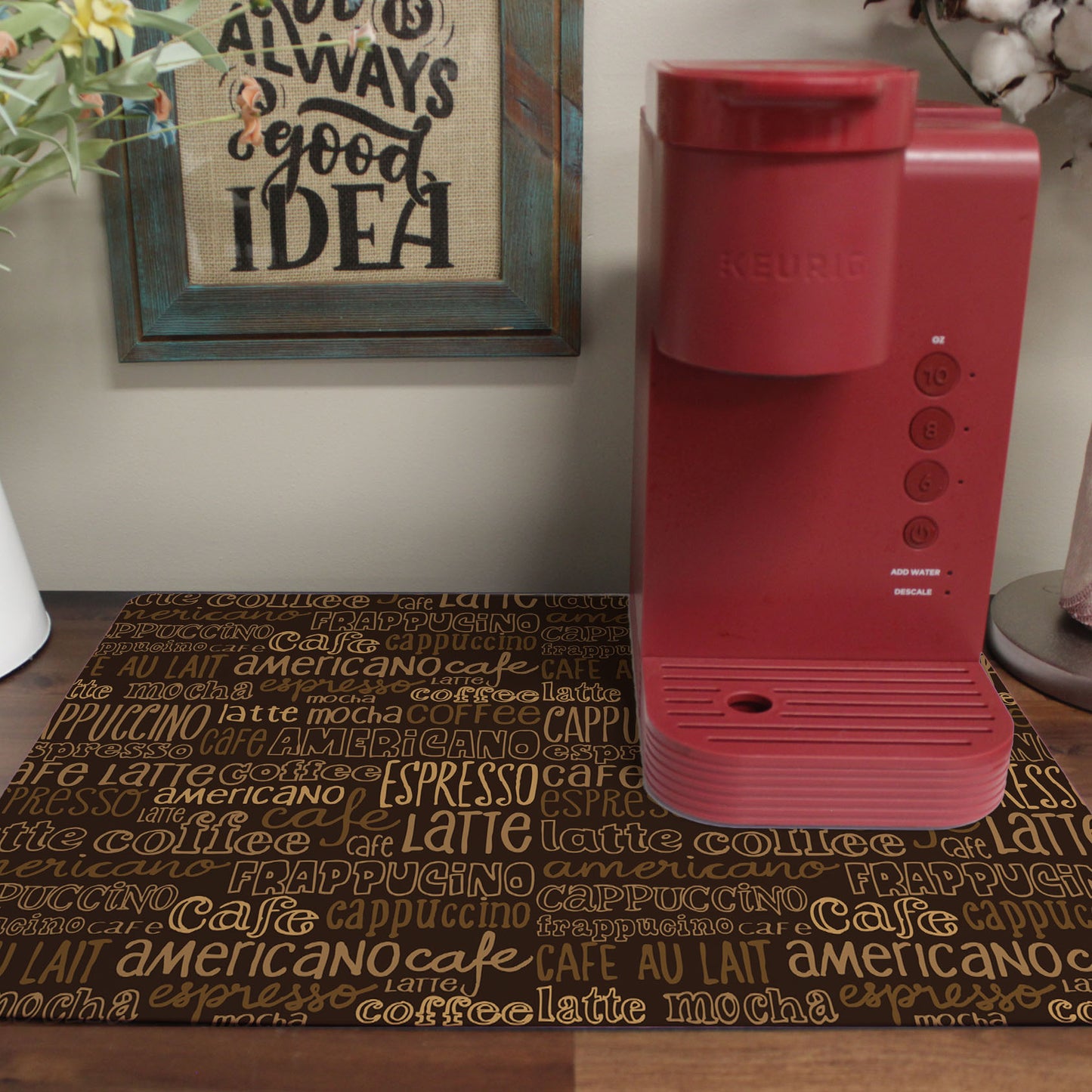 a red coffee maker sitting on top of a wooden table