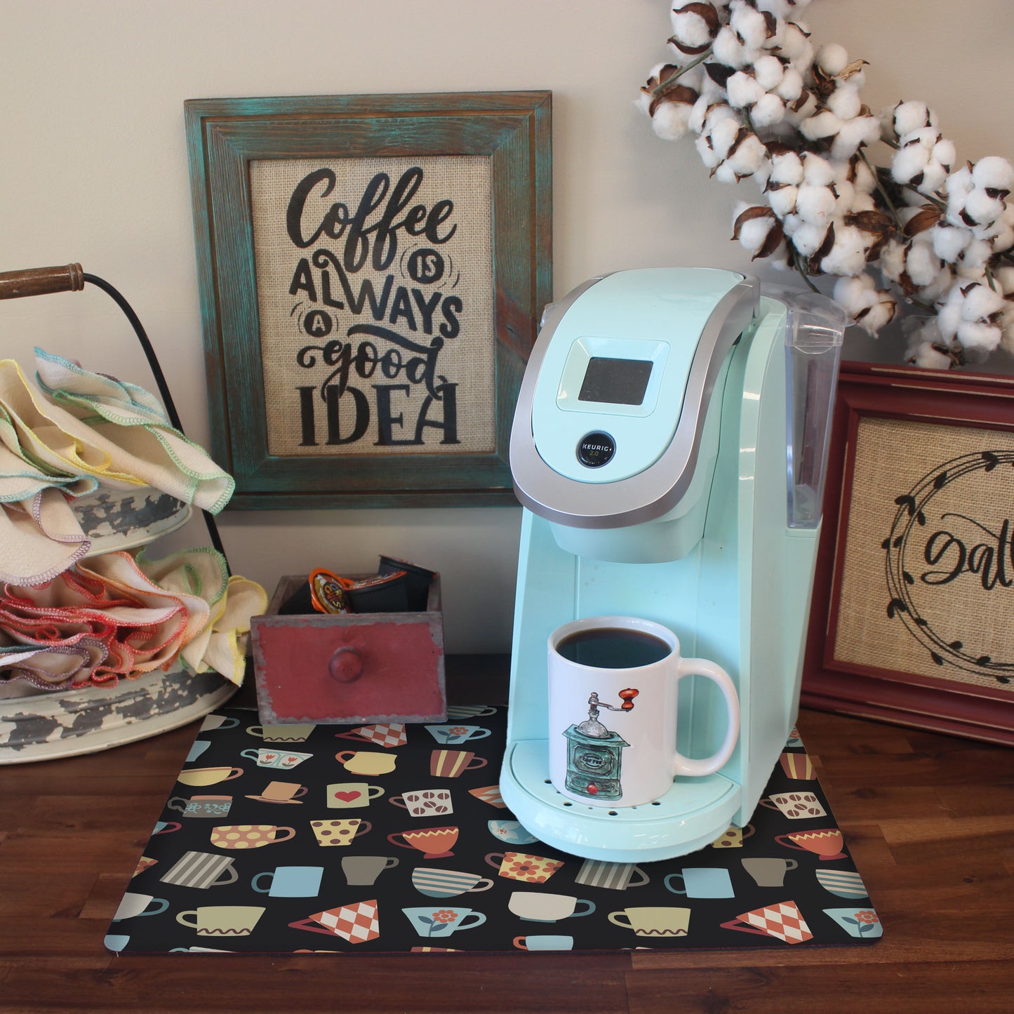 a blue coffee maker sitting on top of a wooden table