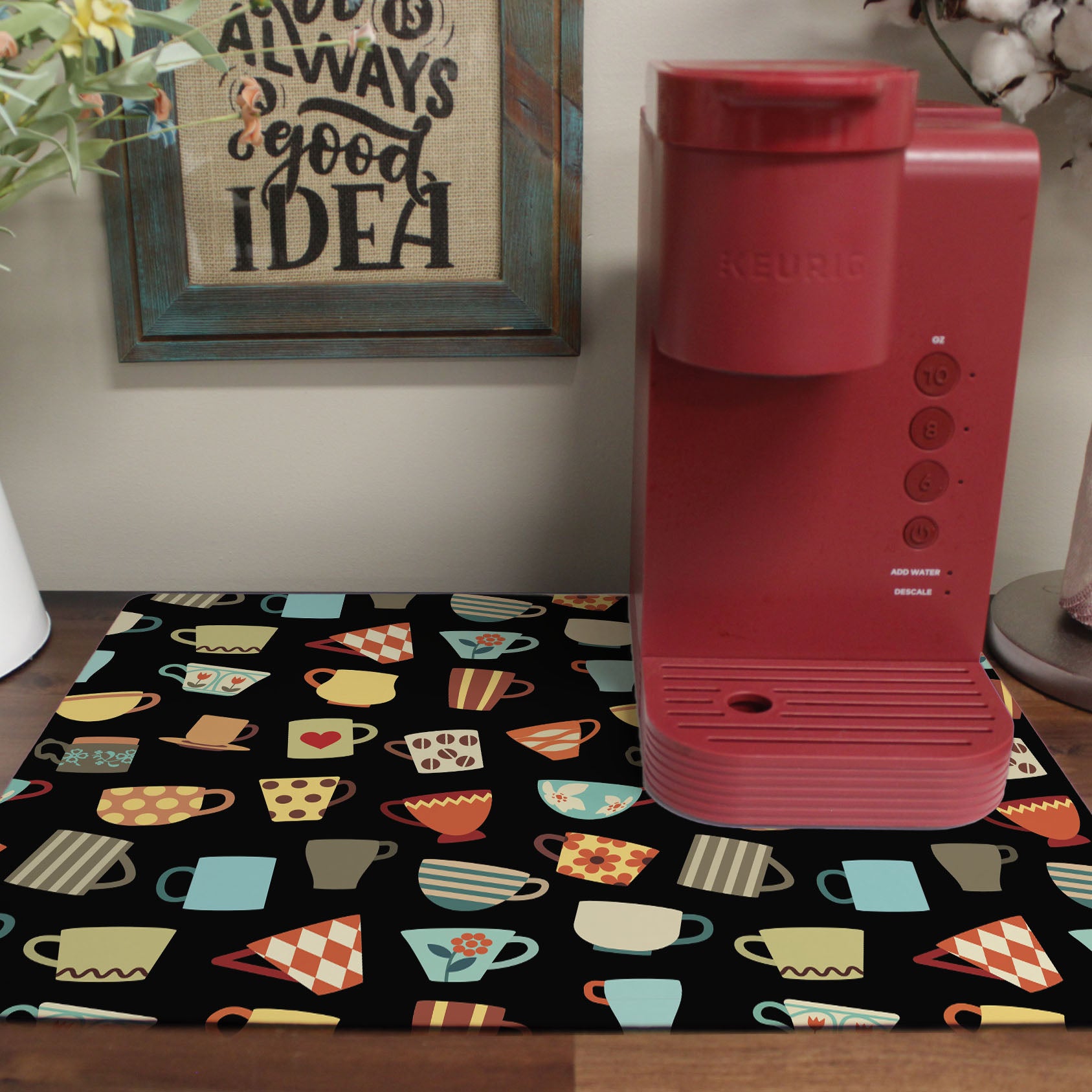 a red coffee maker sitting on top of a table