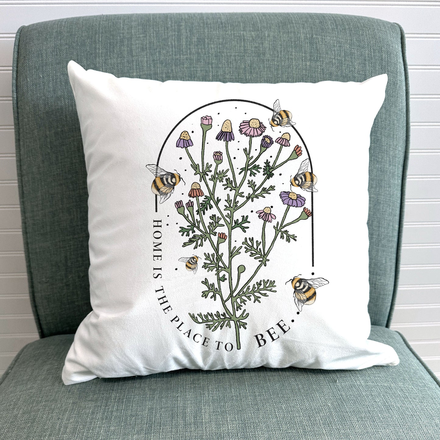 a pillow with a picture of a plant with bees on it